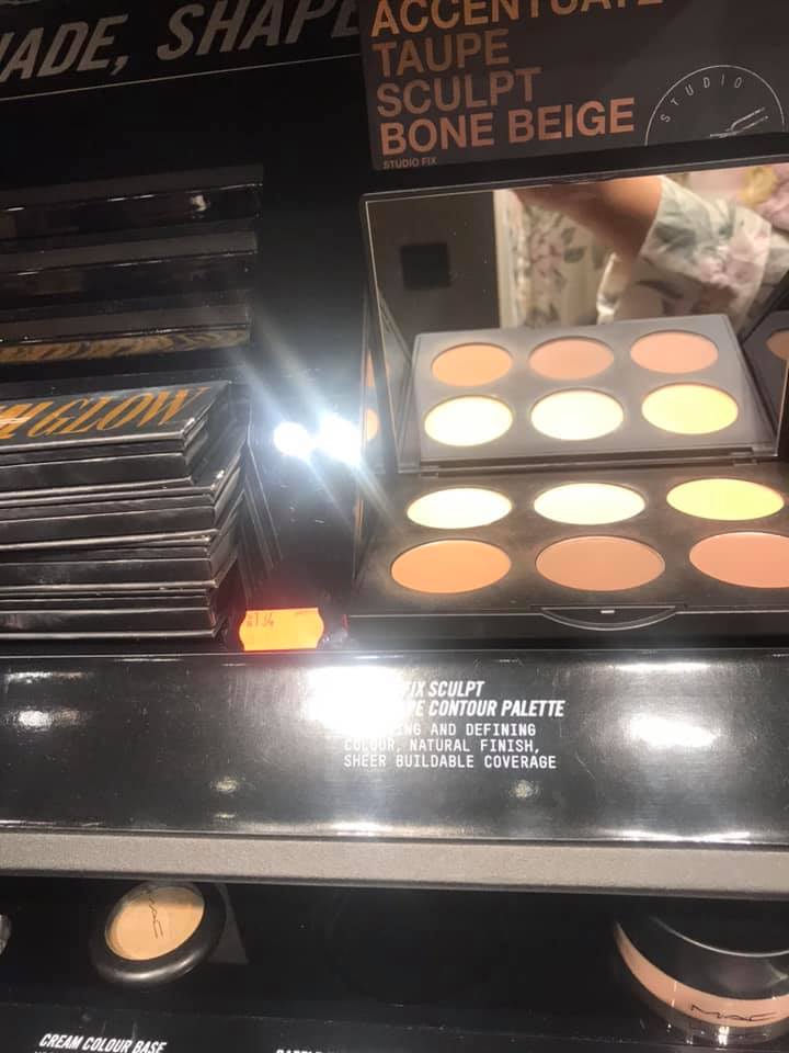 A display of makeup palettes and products, featuring contour shades and foundations.