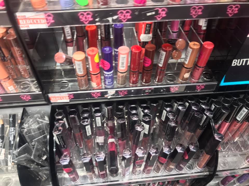 A display of various lipsticks and lip glosses from the NYX brand.