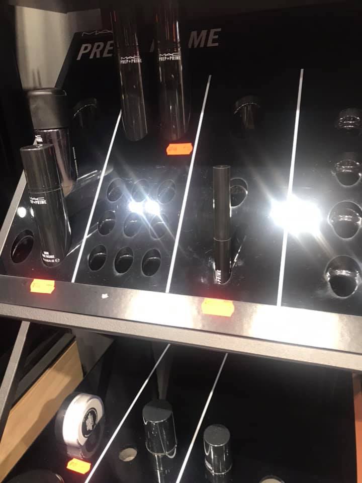 A display of MAC Prep + Prime products, including sprays and primers.