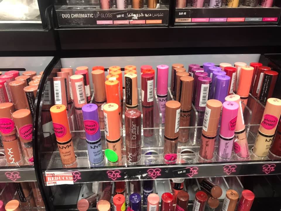 A display of various NYX lip glosses and lipsticks in a retail store.