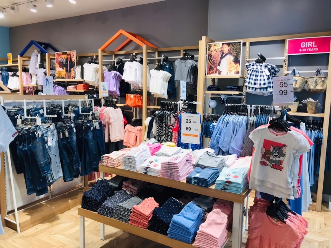 Interior view of a brightly lit OVS Kids store showcasing a variety of children's clothing.