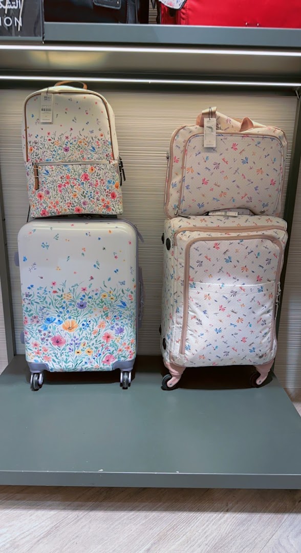 A display of floral and dragonfly patterned luggage and backpacks from Parfois.