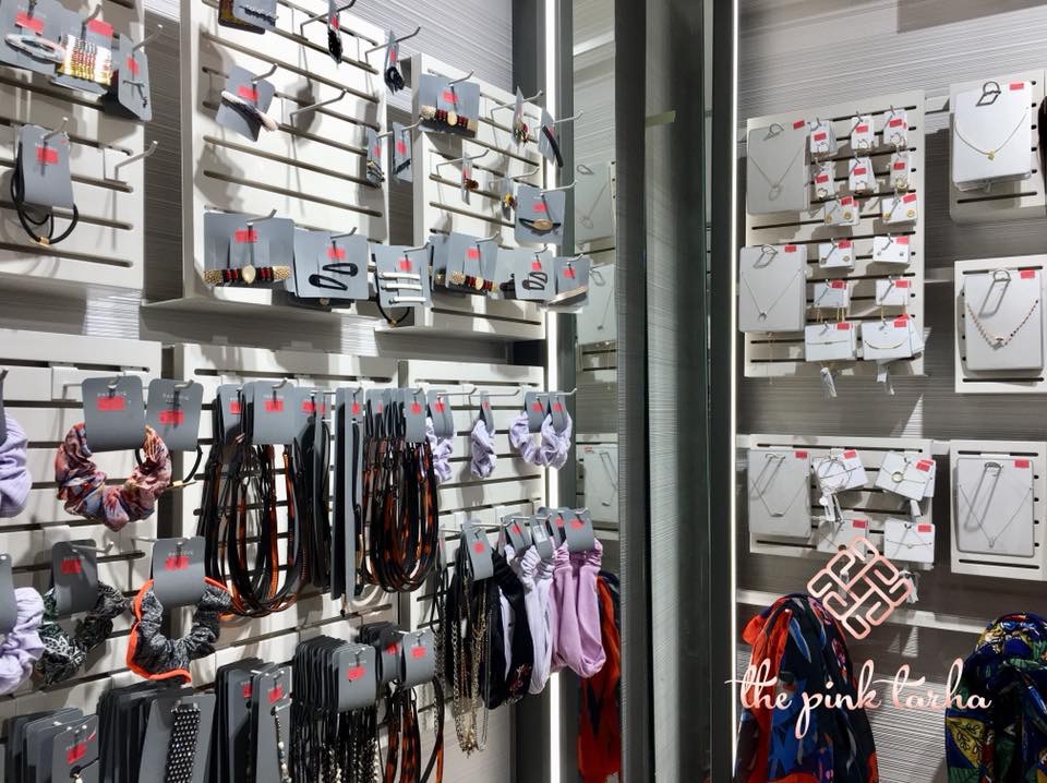 A well-organized display of fashion accessories including necklaces, hair ties, and hair clips.