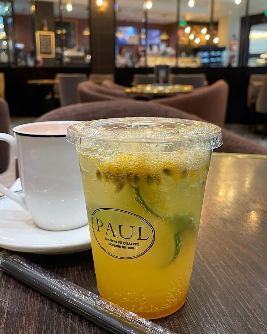 A refreshing passion fruit and lime drink with a cup of coffee at Paul Le Cafe.