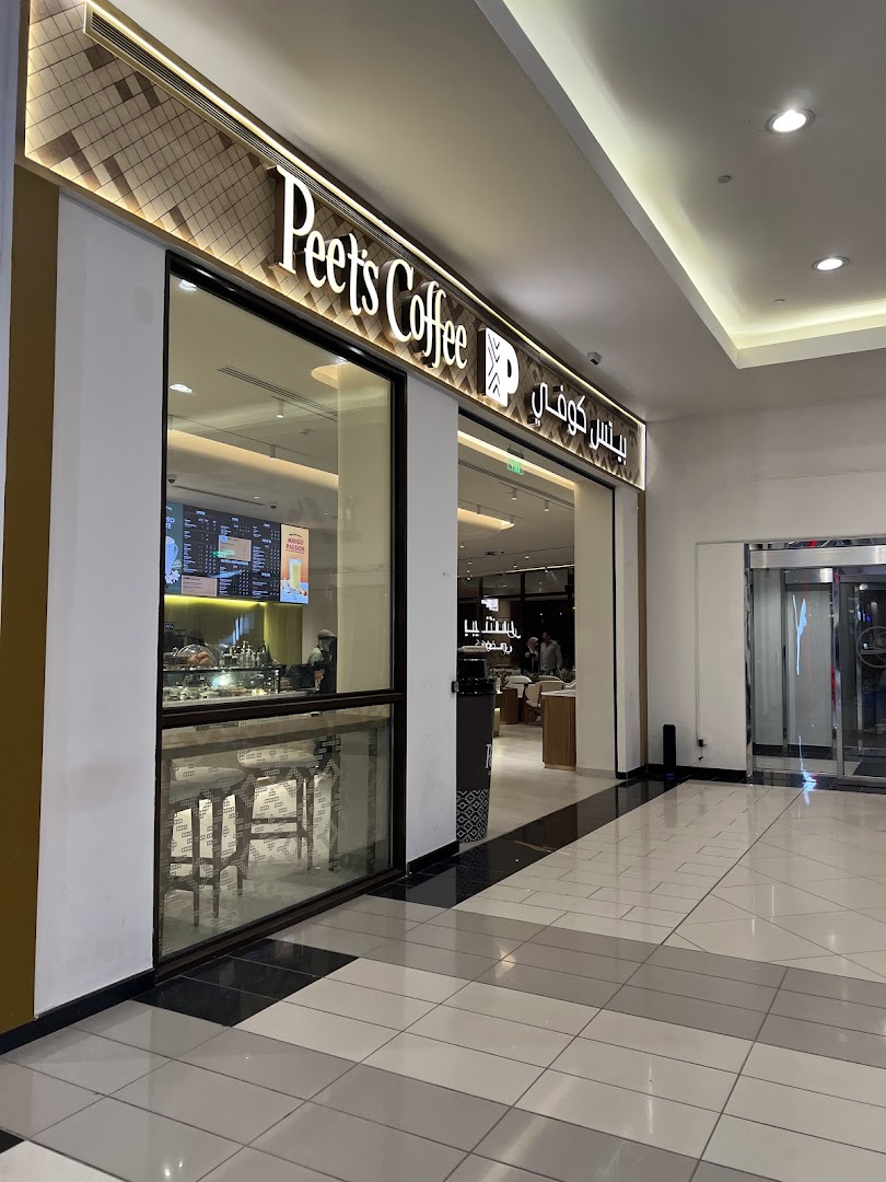 The exterior of Peet's Coffee at Granada Mall, featuring a prominent sign and large windows.