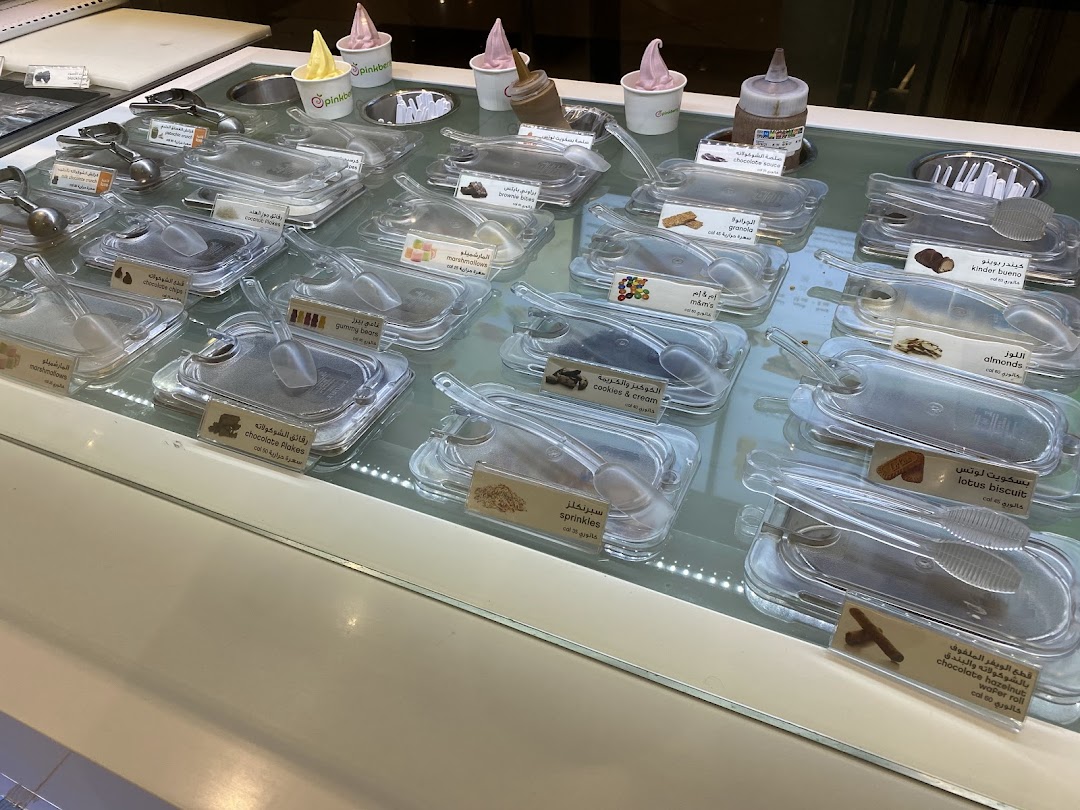 A display case filled with various toppings and frozen yogurt flavors at Pinkberry.