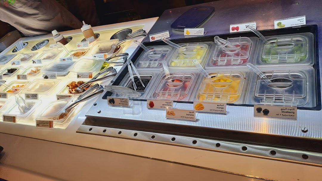 A display of fresh fruit toppings and sauces for frozen yogurt.