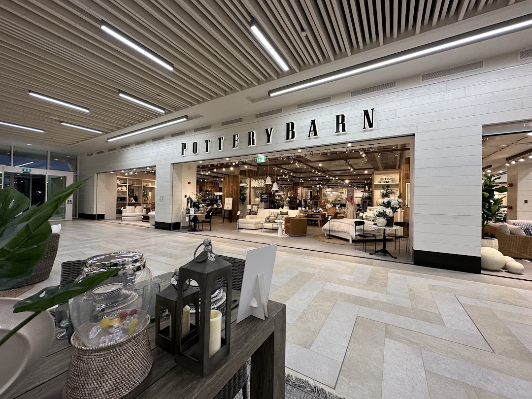 The Pottery Barn store entrance showcasing a well-lit interior with furniture and decor.