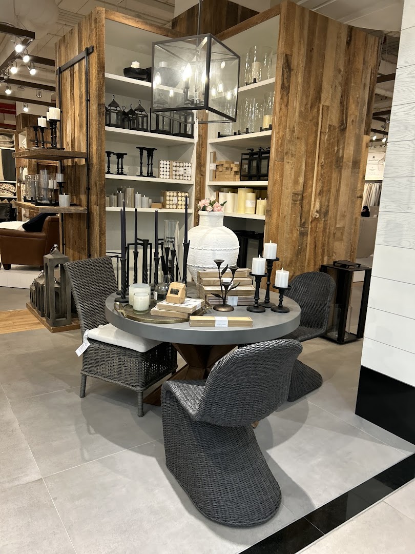 A dining table set with chairs and decorative items in a home furnishings store.