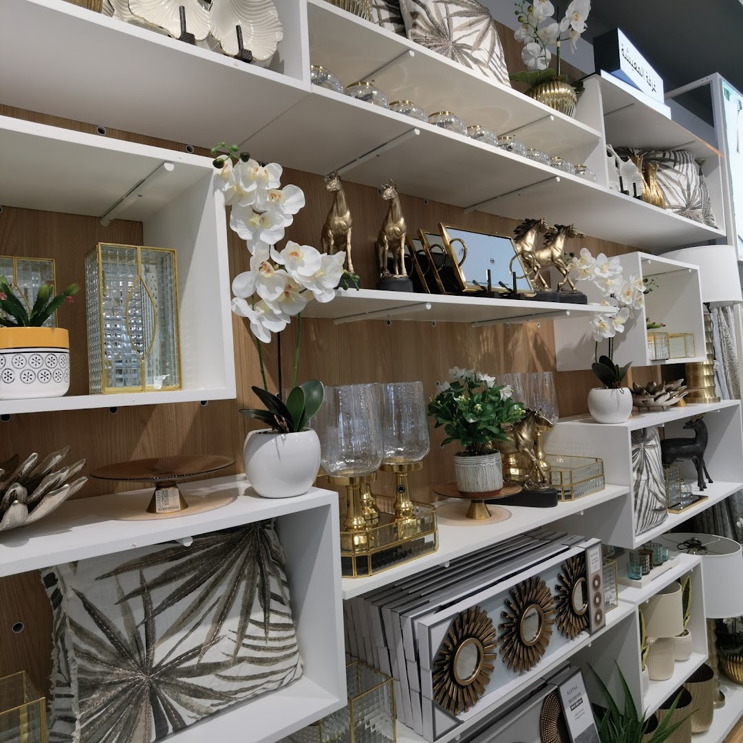 Shelves filled with decorative items including vases, sculptures, pillows, and artificial flowers.