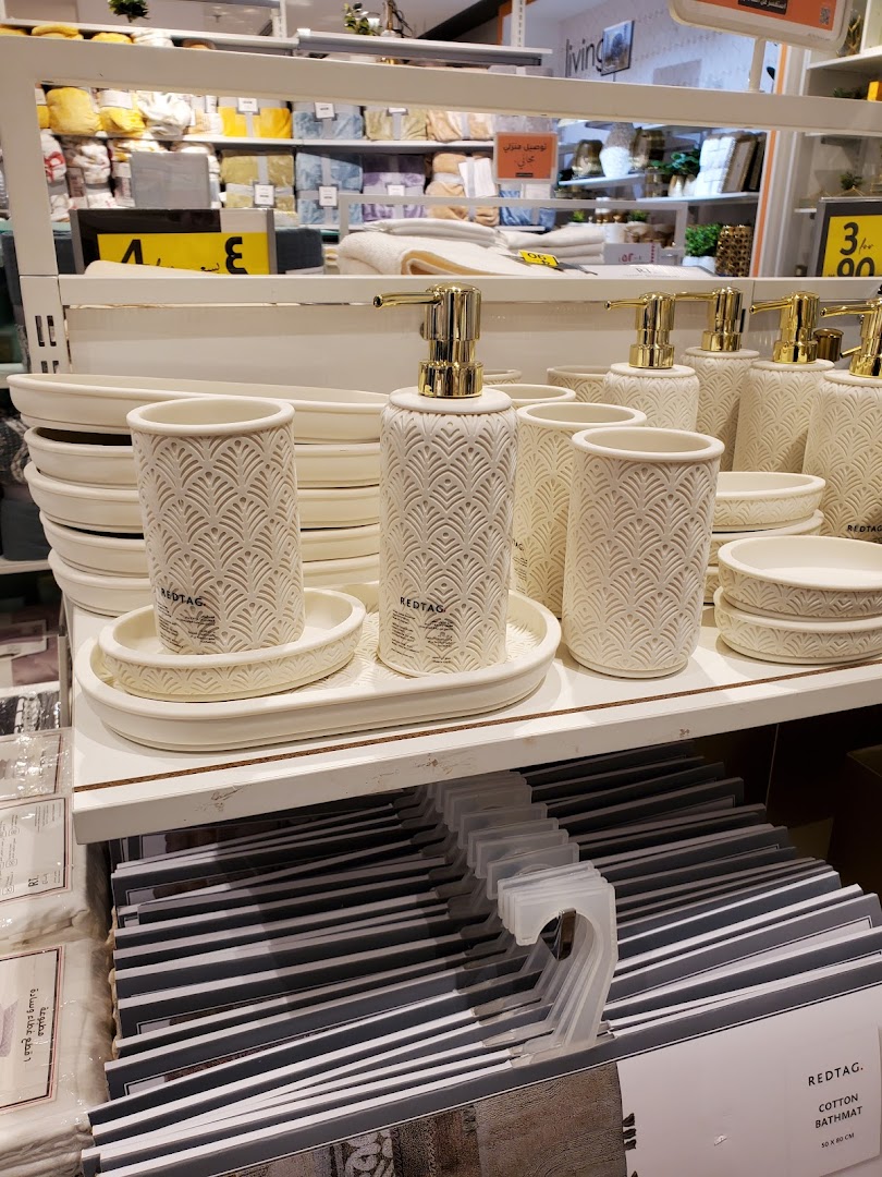 A display of decorative bathroom accessories and bath mats at Redtag.
