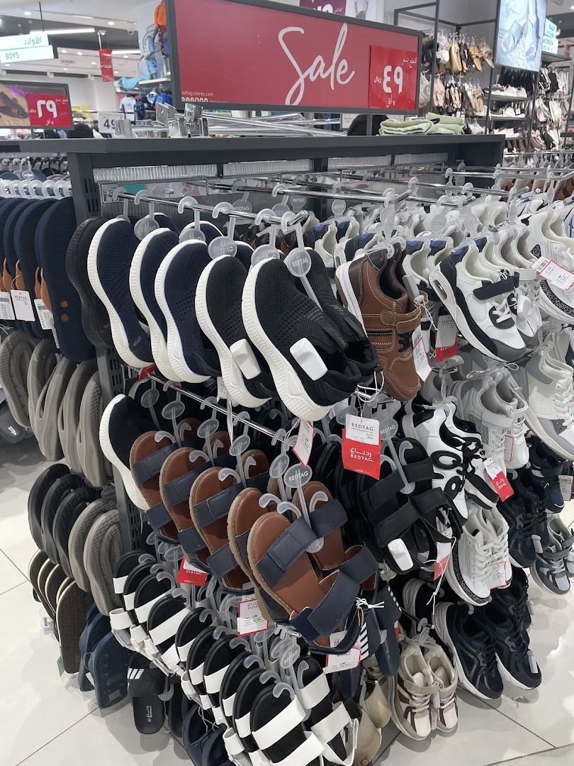 A display of various footwear including sandals and sneakers, with a prominent 'Sale' sign.