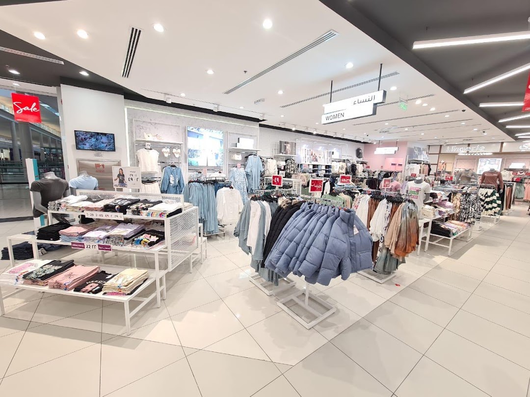 Interior view of a Redtag clothing store showcasing various apparel for women and men.