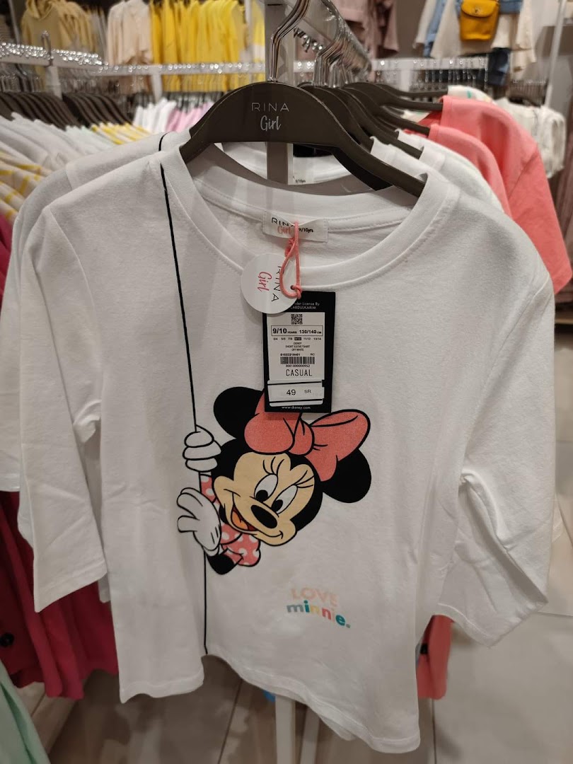 A white t-shirt with a Minnie Mouse graphic and 'Love Minnie' text is displayed on a hanger.
