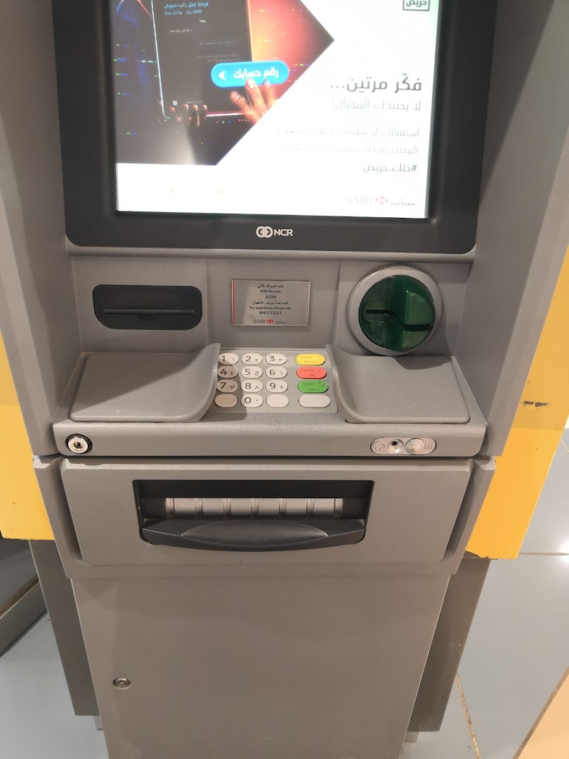 An ATM machine with a screen displaying a promotional message and a keypad.