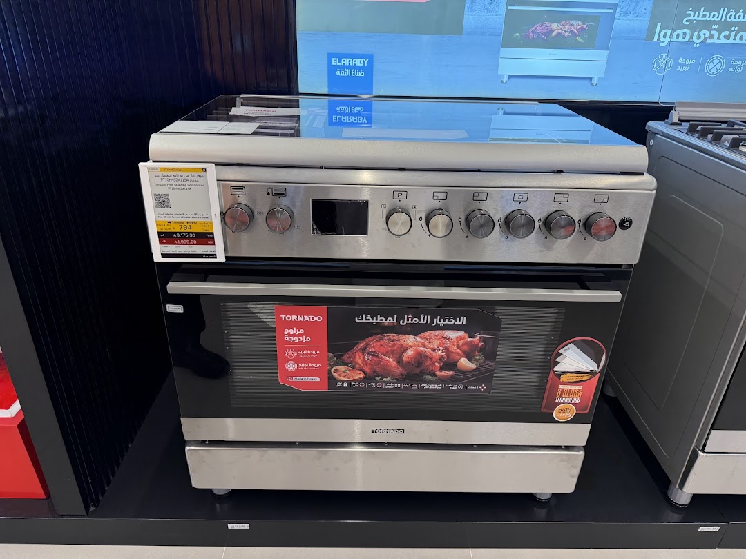 A stainless steel gas oven with a glass top and a display showing a roasted chicken.