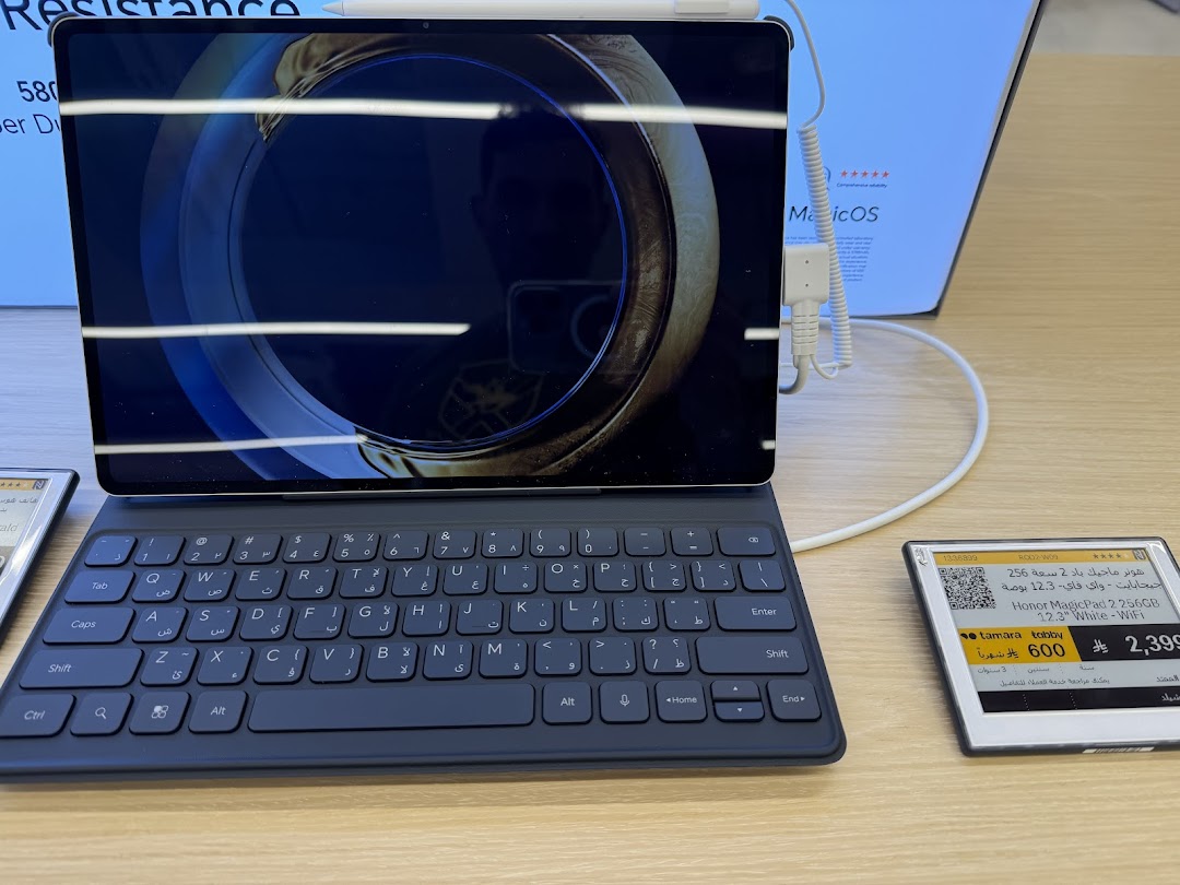 A tablet with a keyboard attachment and a price tag displaying product information.