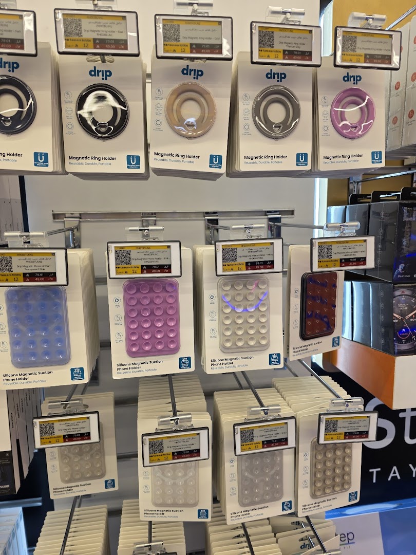 A display of various phone holders, including magnetic ring holders and silicone suction holders.