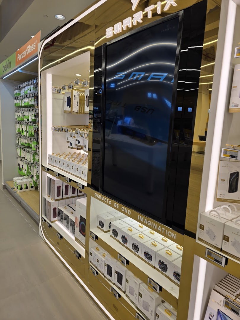 A well-lit retail display showcasing various electronic gadgets and accessories, including smartwatches and phone cases.