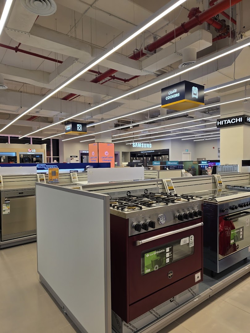 Interior view of a Sharaf DG electronics store showcasing various kitchen appliances like cookers and dishwashers.