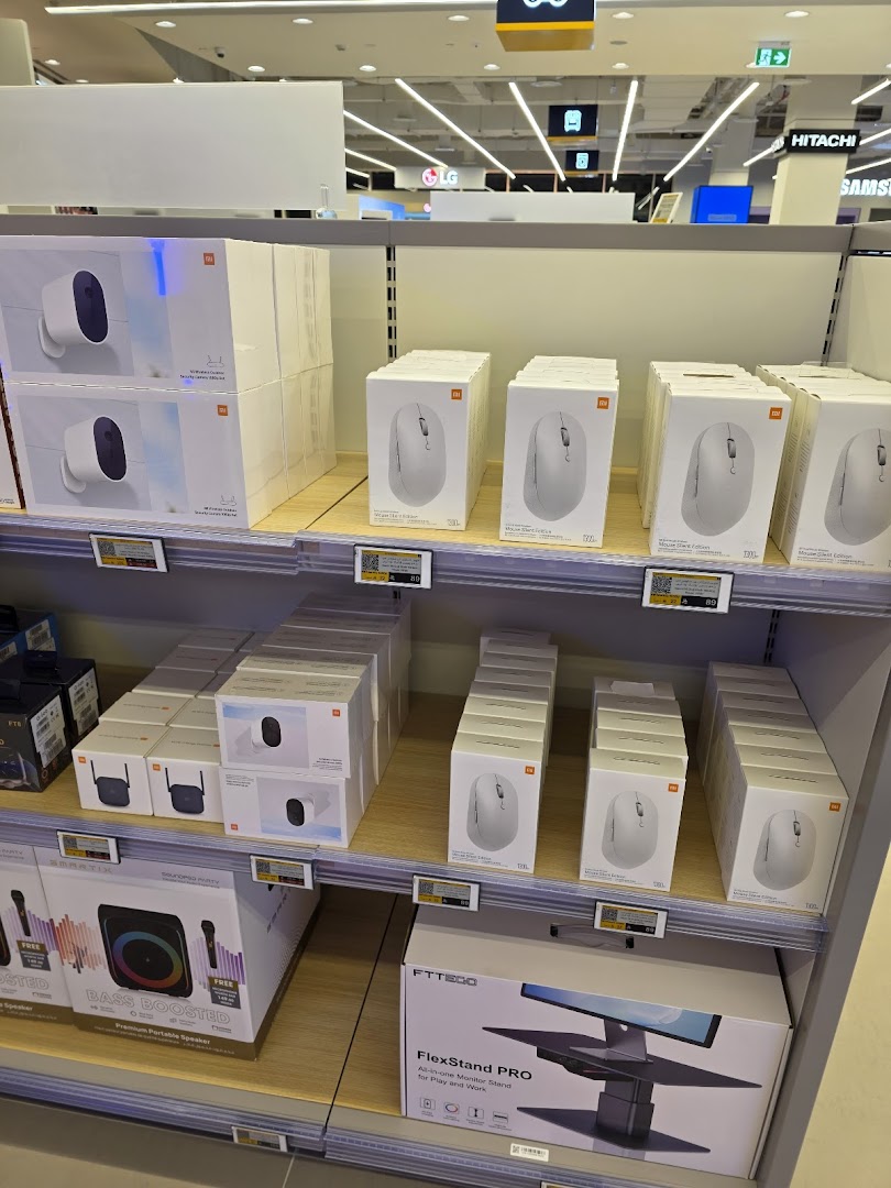 Shelves stocked with Xiaomi wireless mice, security cameras, and a monitor stand.