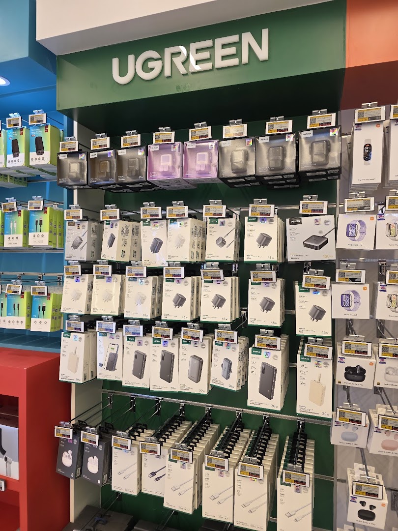 A display of UGREEN brand electronic accessories, including chargers, cables, and smartwatches.