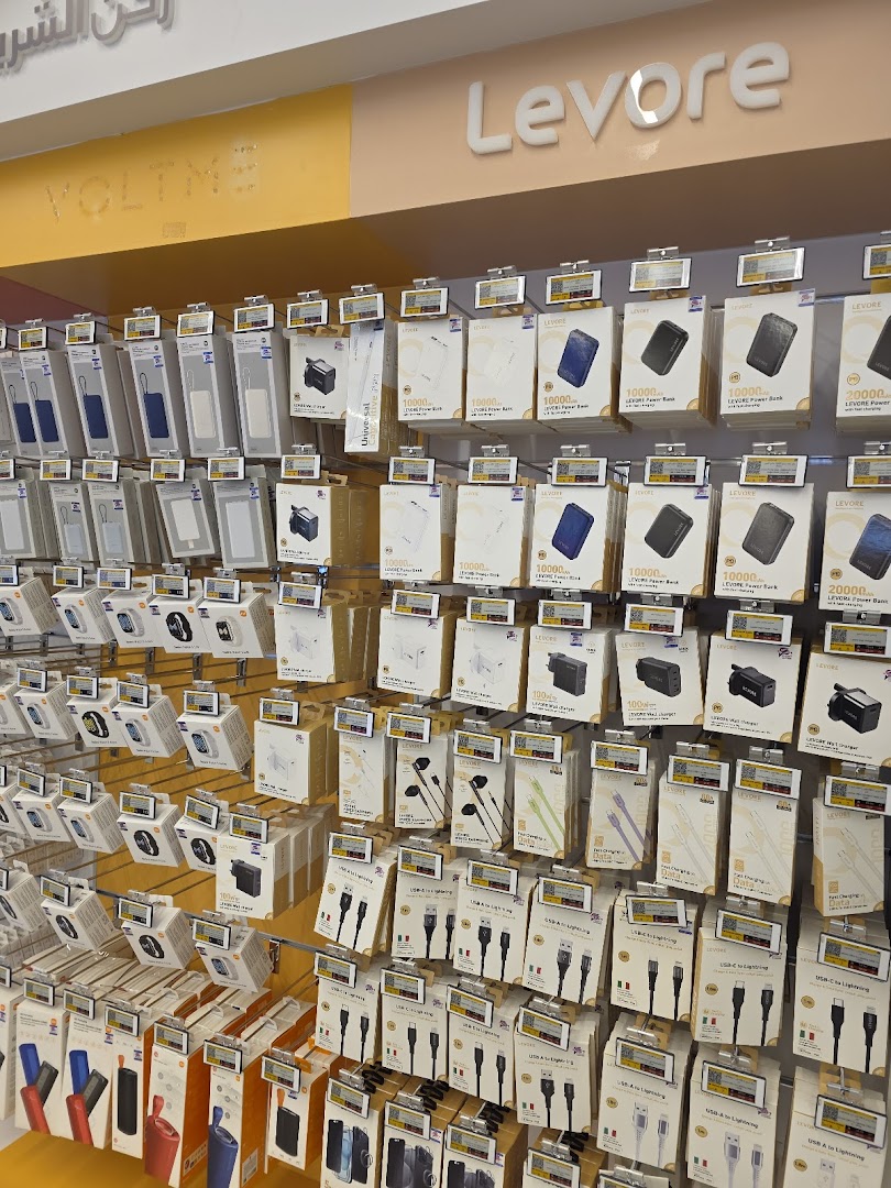 A wall display showcasing various electronic accessories like power banks, chargers, and cables.