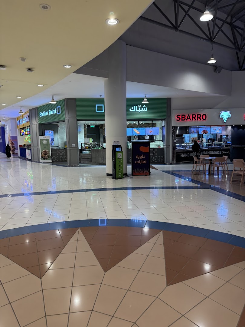 The exterior of Shebbak Beirut restaurant and Sbarro in a mall, with customers visible.