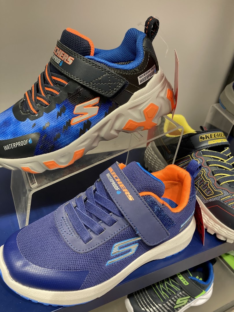 Close-up view of Skechers children's shoes, featuring waterproof technology and vibrant designs.