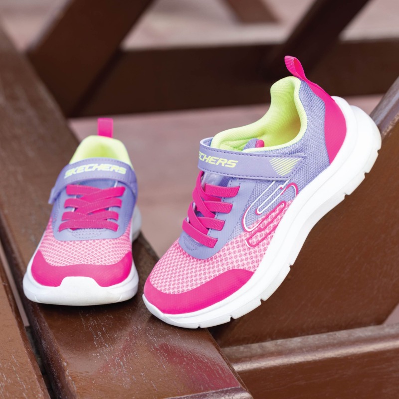 A pair of colorful Skechers children's sneakers with pink and purple accents.