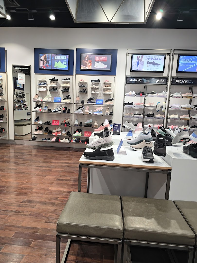 Interior view of a Skechers store showcasing a wide variety of shoes on display shelves.
