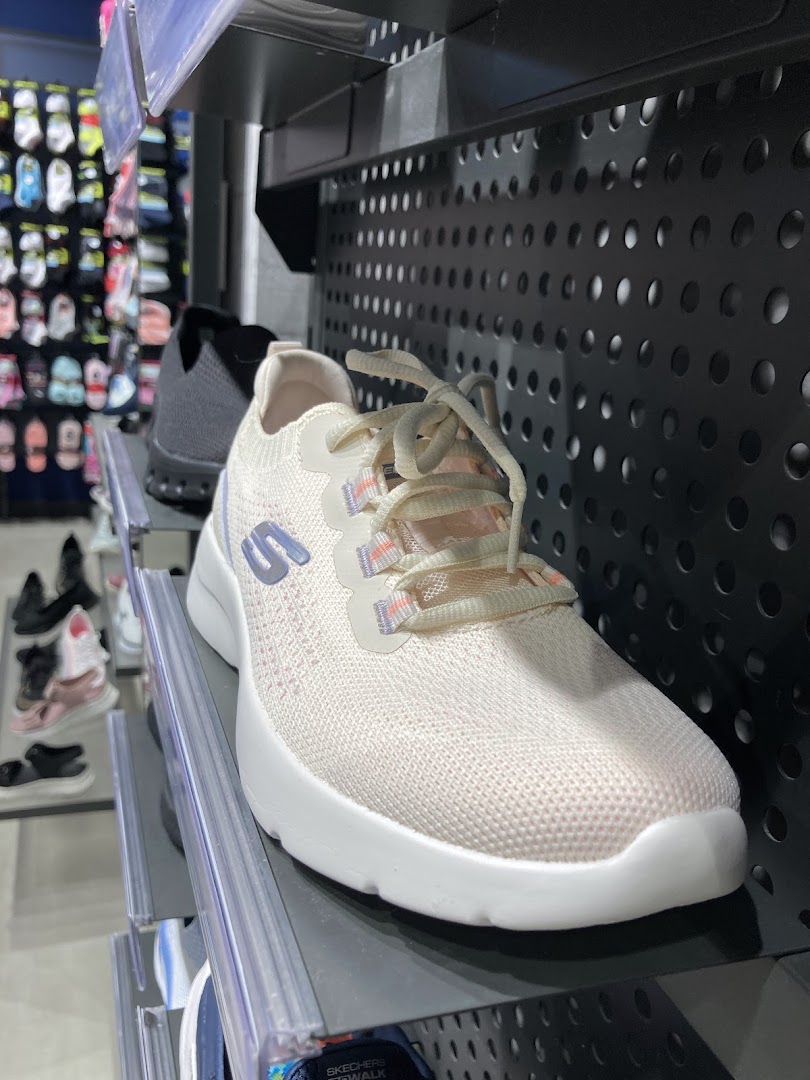 Close-up of a light-colored Skechers sneaker with laces on display.