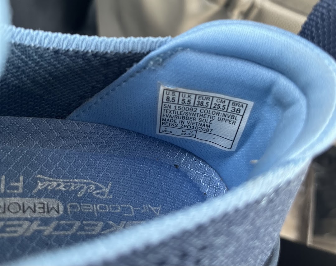 Close-up of the inside of a Skechers shoe showing size and material information.