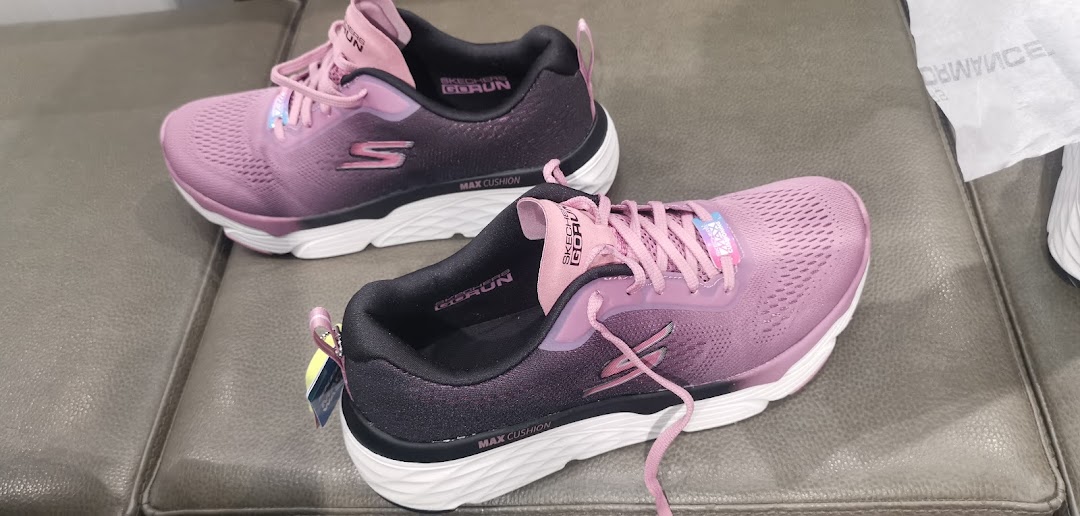 A pair of pink Skechers Go Run shoes with Max Cushion technology.