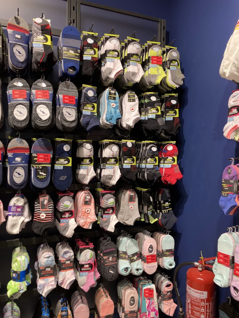 A wall display of various Skechers socks in different colors and styles.