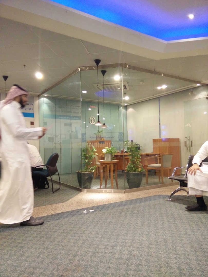 Interior view of a modern office space with glass partitions and seating areas.