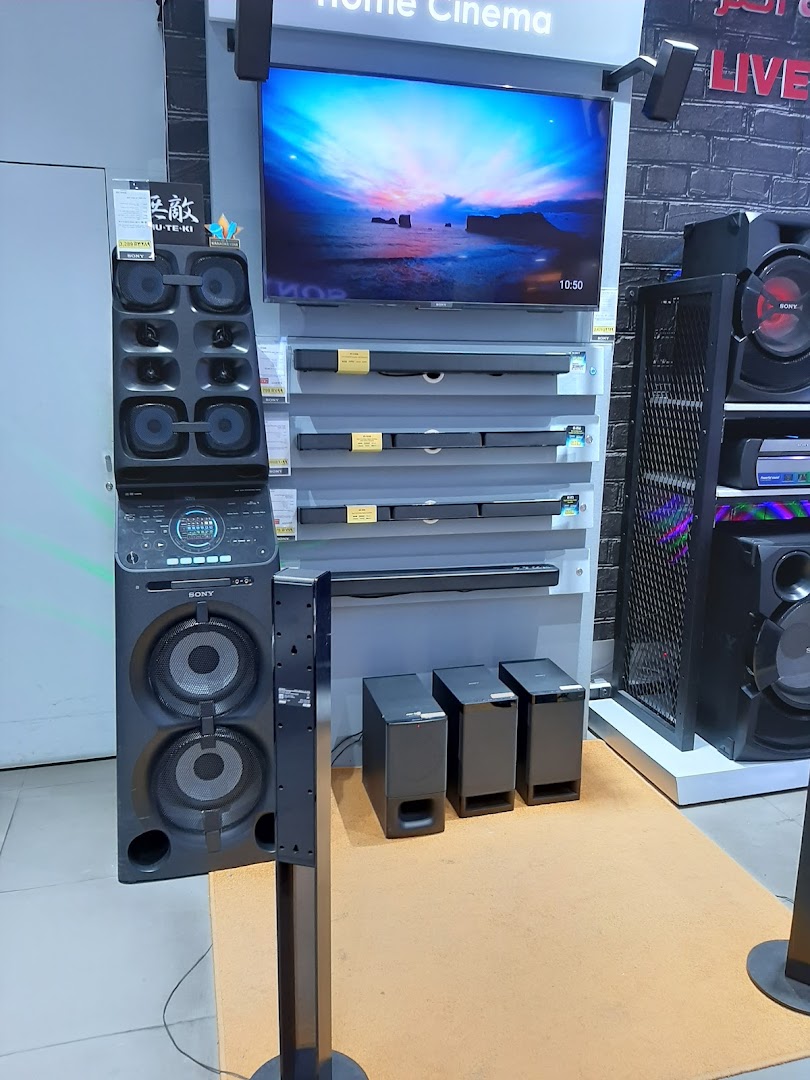 Sony home cinema display featuring a large TV, soundbars, and speaker systems.