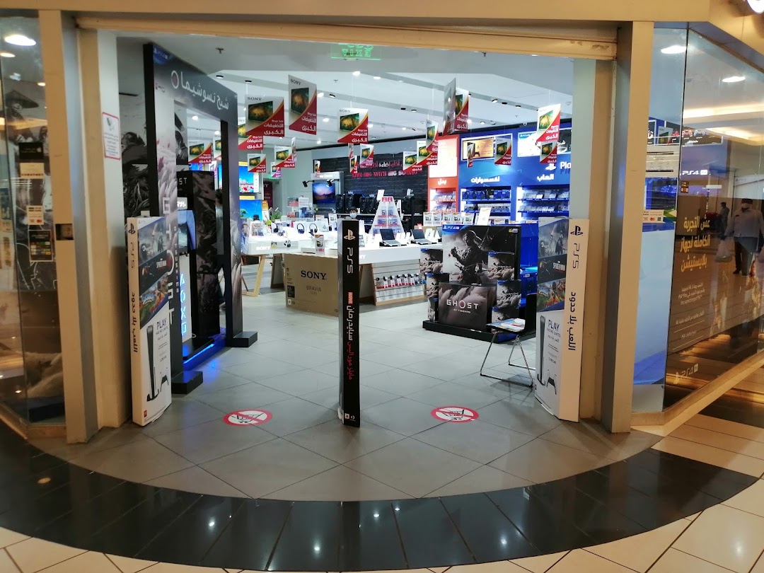 Entrance to a Sony World electronics store showcasing PlayStation consoles and accessories.