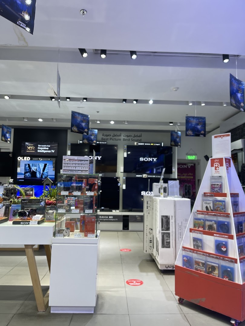 Interior of a Sony electronics store showcasing TVs, cameras, and video games.