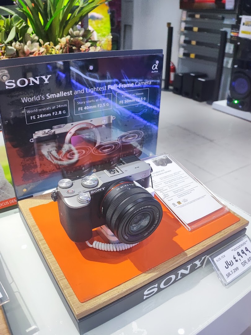 A Sony Alpha full-frame camera displayed with marketing materials and price tag.