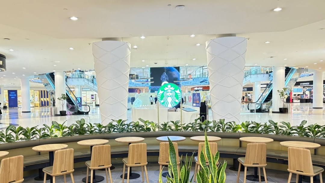 Interior view of a Starbucks cafe with seating and the iconic logo visible.