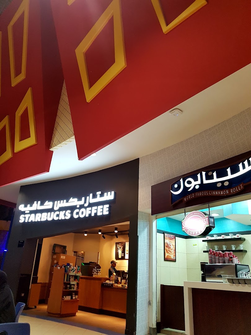 The entrance to a Starbucks Coffee shop and a Cinnabon shop next to it.