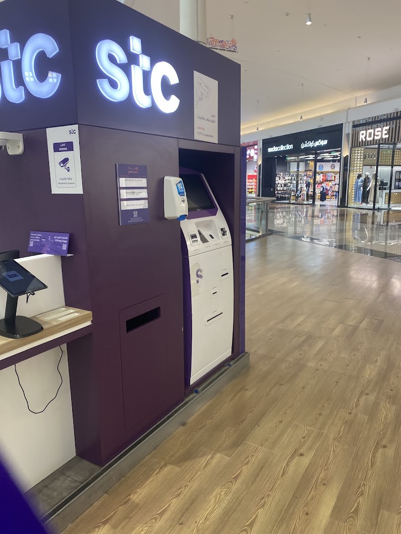 The stc store kiosk with a self-service machine and signage in a shopping mall.