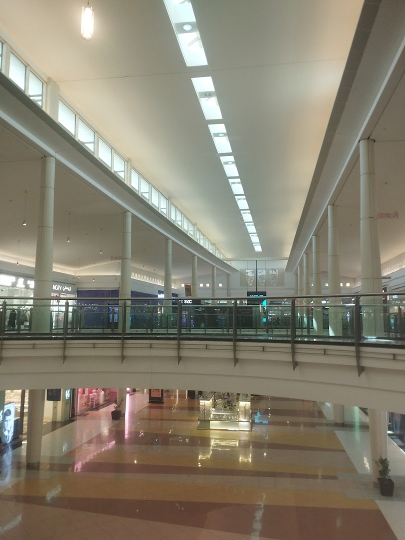 Interior view of a modern shopping mall with multiple levels and shops.