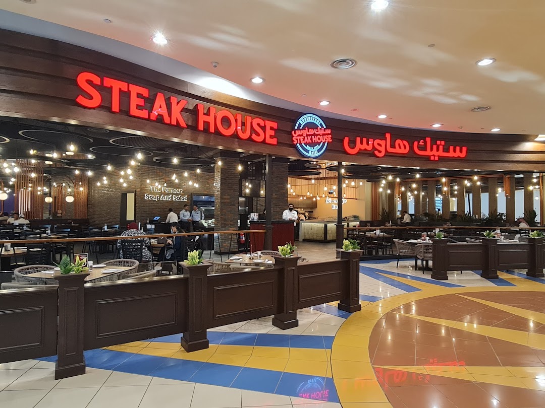 The Steak House restaurant entrance with illuminated signage and dining area visible.