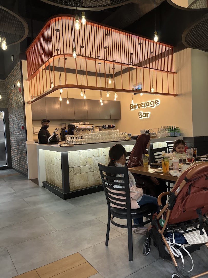 Interior of a steakhouse with a beverage bar and diners seated at tables.