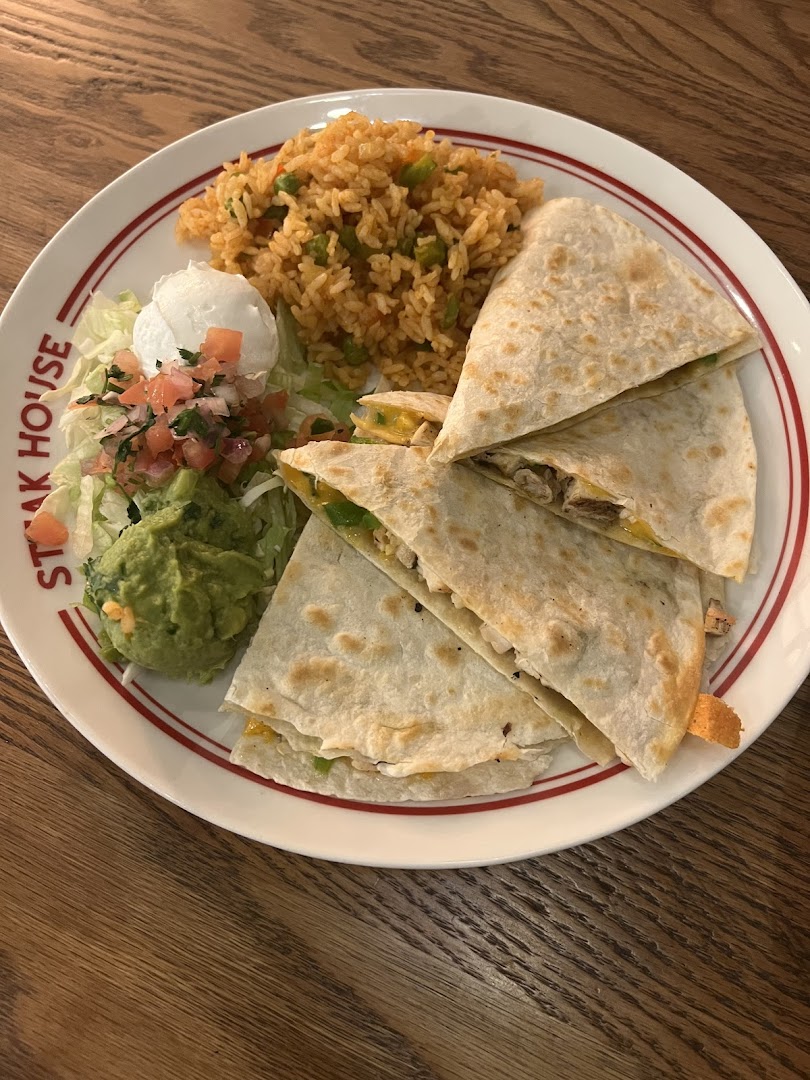 A plate of quesadillas with rice, guacamole, and salad from Steak House.