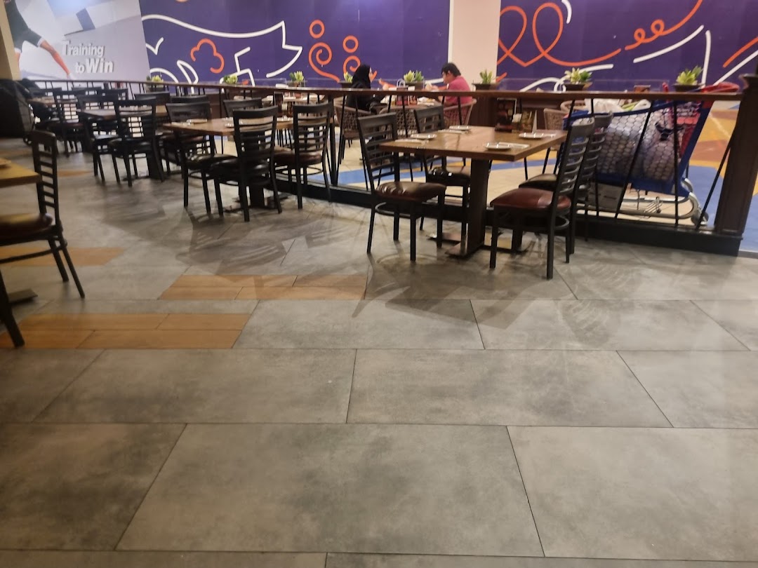 Interior view of a steakhouse with tables and chairs set up for dining.