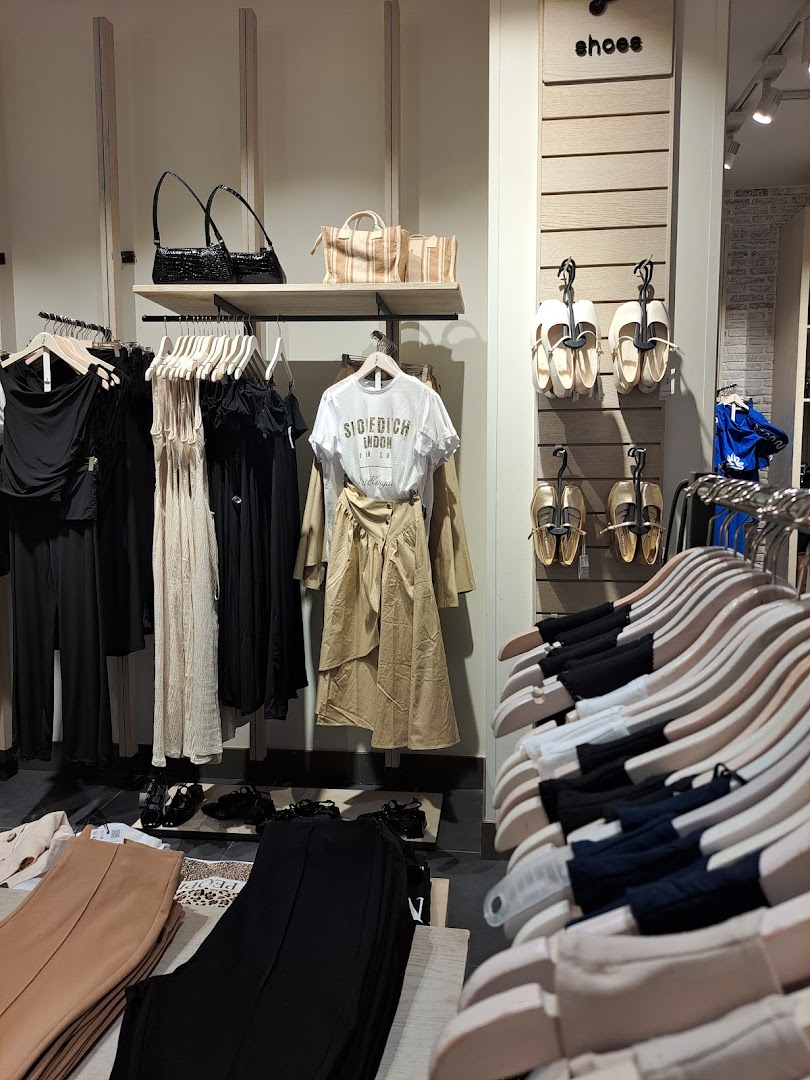 Stradivarius shop interior displaying women's clothing, shoes, and handbags.