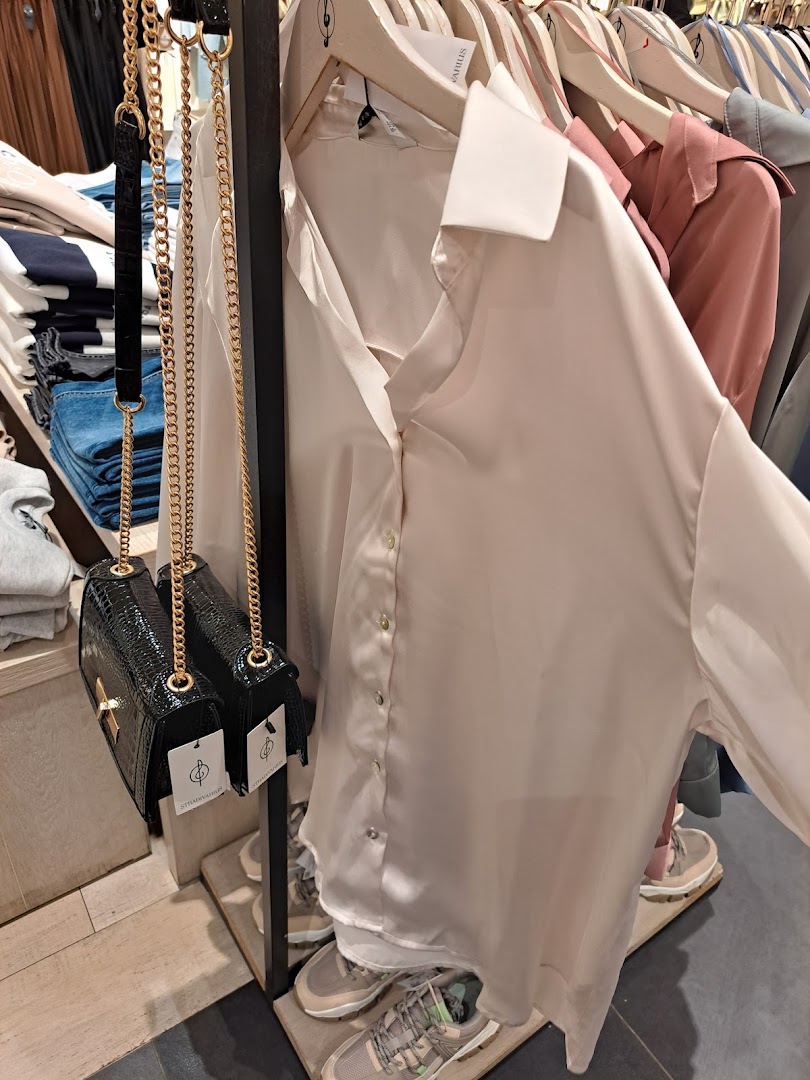 A close-up view of stylish women's clothing and accessories on display.